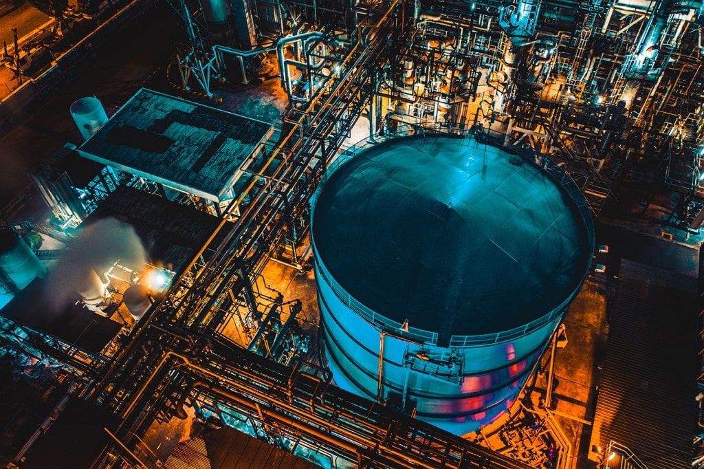 Distillation tank of oil refinery plant at night